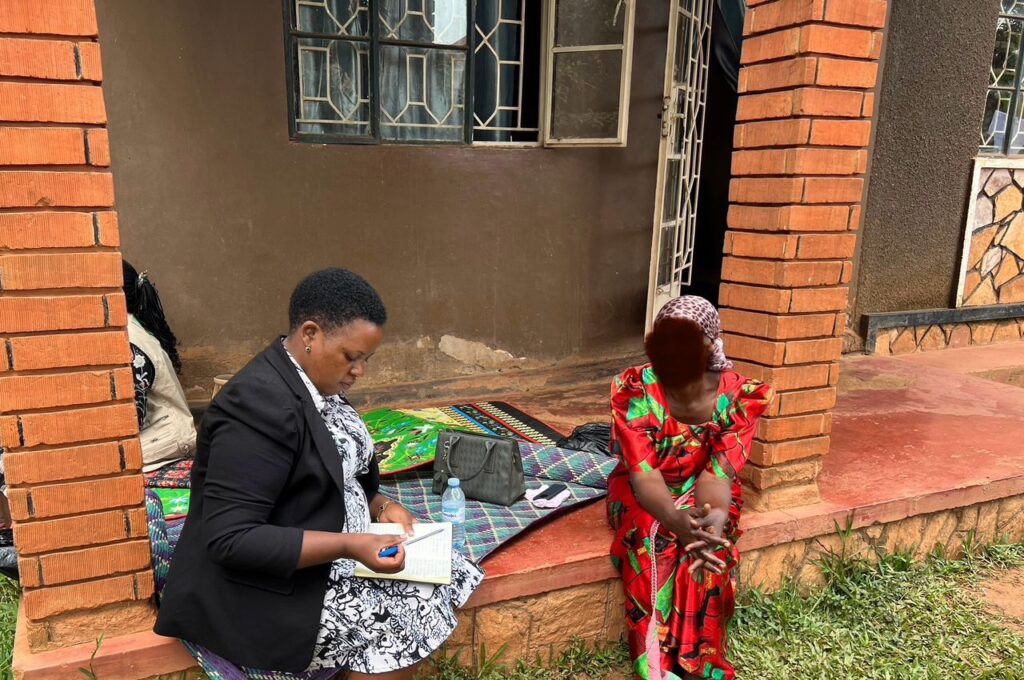 A legal officer from UGANET engaging one of the survivors to determine the right legal course of action
